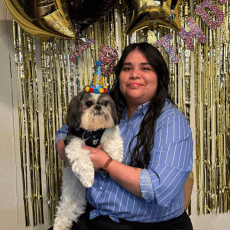 Cristina Munoz holding dog and smiling